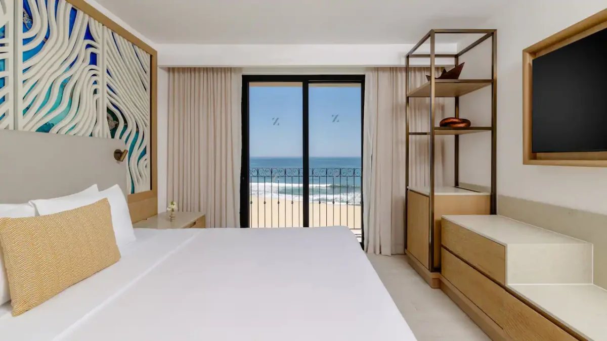 Club Deluxe Oceanfront One Bedroom Suite bedroom with king bed and oceanfront balcony at Hyatt Ziva Los Cabos.