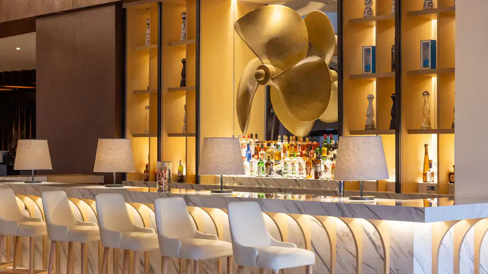 Lobby Bar 23°N at Hyatt Ziva Los Cabos featuring elegant lounge seating, handcrafted cocktails, and a sophisticated resort atmosphere.